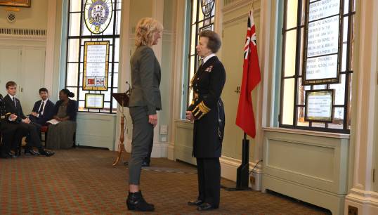 Image:Sharon Coveney, MNWB deputy chief executive at the MNWB, receives her Merchant Navy Medal from HRH The Princess Royal. Image: Mark Dalton