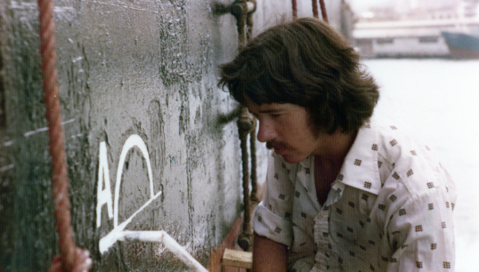 Image:Nautilus member Trevor Boult painting a Plimsoll line onto a vessel as a cadet in the 1970s. Image: courtesy of Trevor Boult